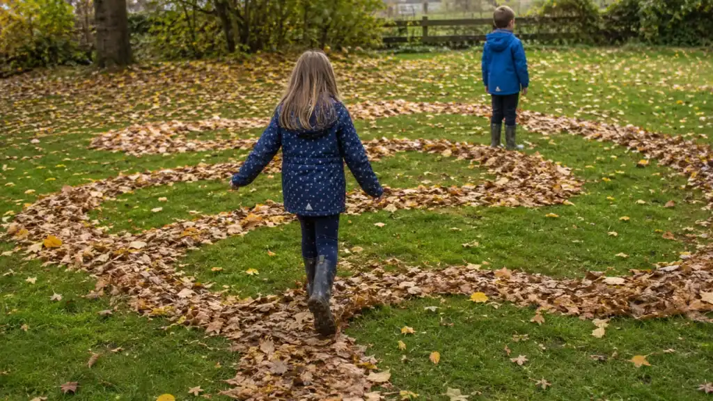 Outdoor leaf activity for kids walking through a maze made from fall leaves